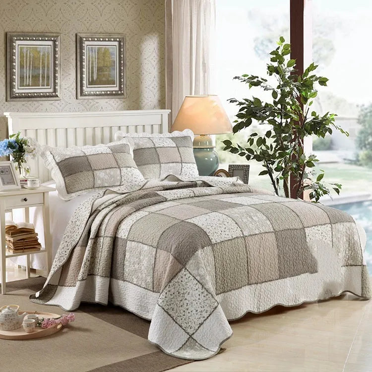 Washed pure cotton quilted bedspread and pillowcases three-piece bedding set on a bed.