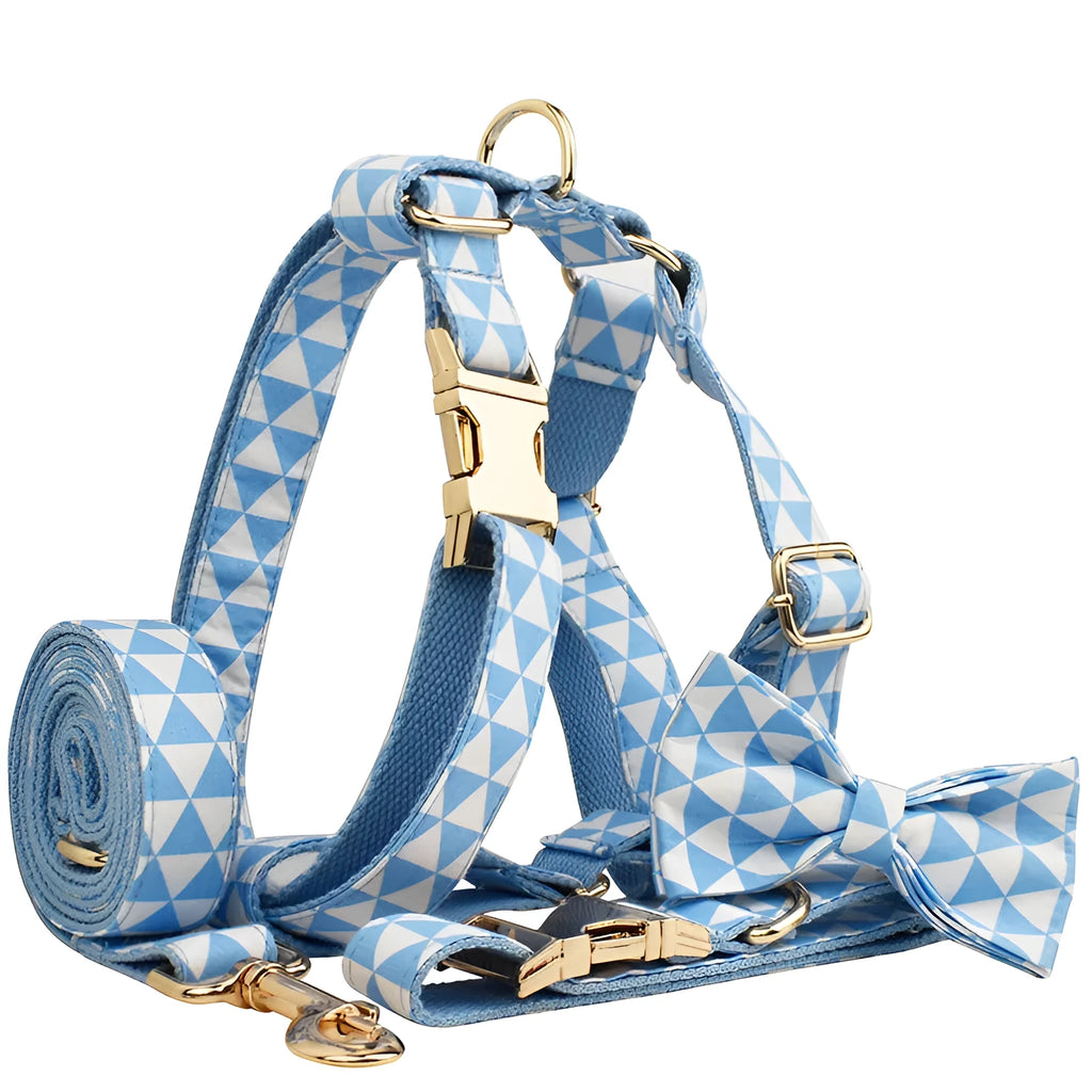 Blue cloth dog collar, leash, vest, and bow set arranged together showing all four pieces.