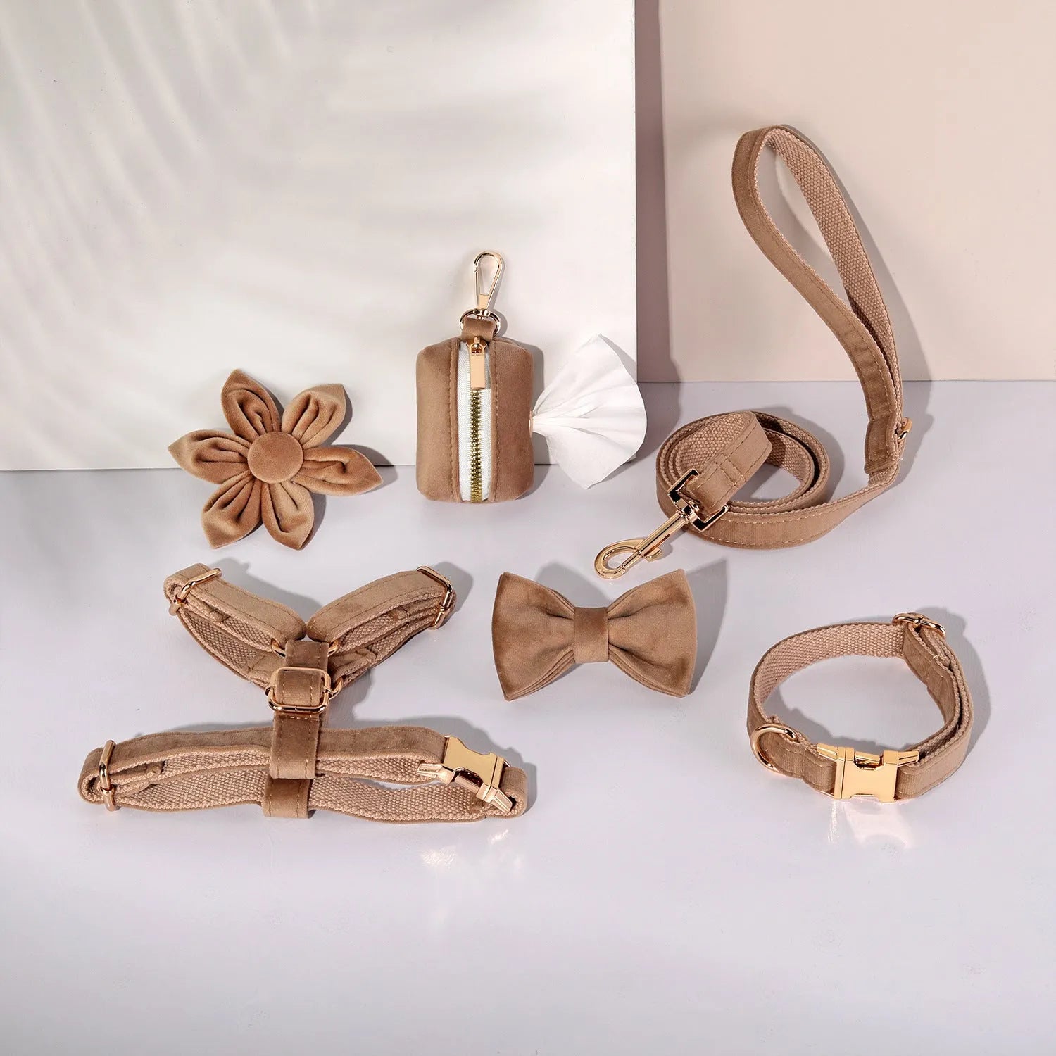 Complete velvet dog collar and traction rope set with bow tie, flower, and toilet bag on a table