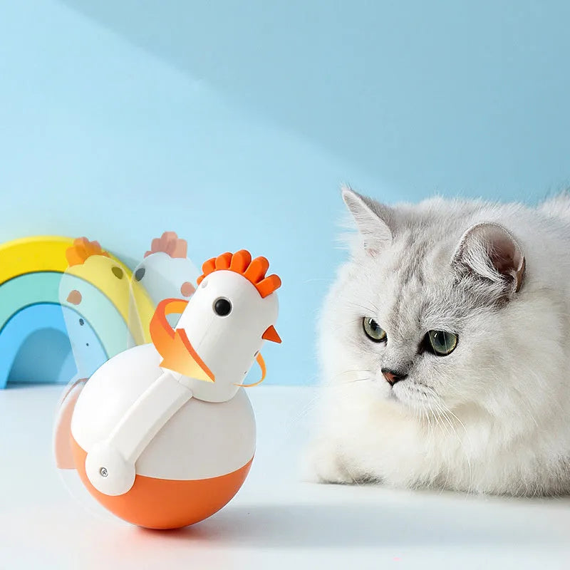 Green and orange electric cat toy chicken shape with laser light and motion features on a floor.