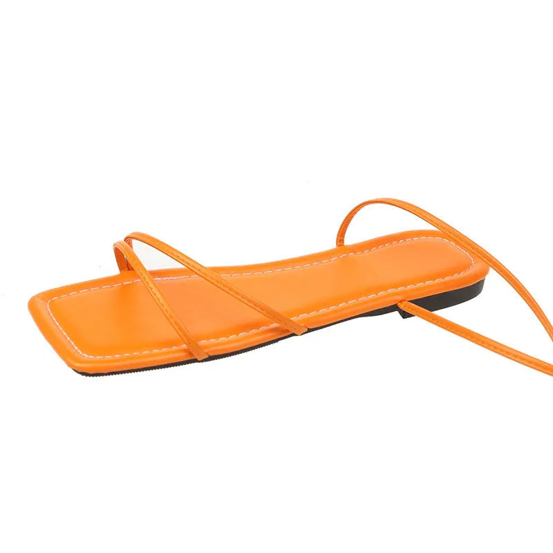 Women's flat sandals with a black PU upper, ankle ring bandage strap, front lace-up, and square toe.