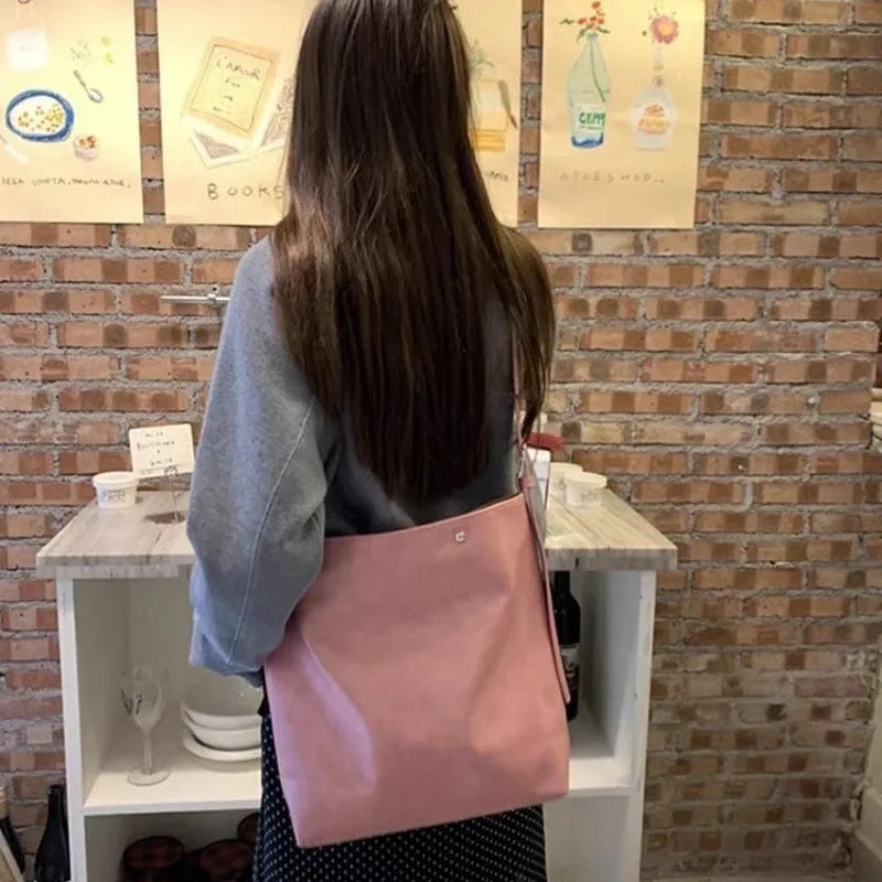 Corduroy commuter shoulder bag in pink colour with one-shoulder carry design