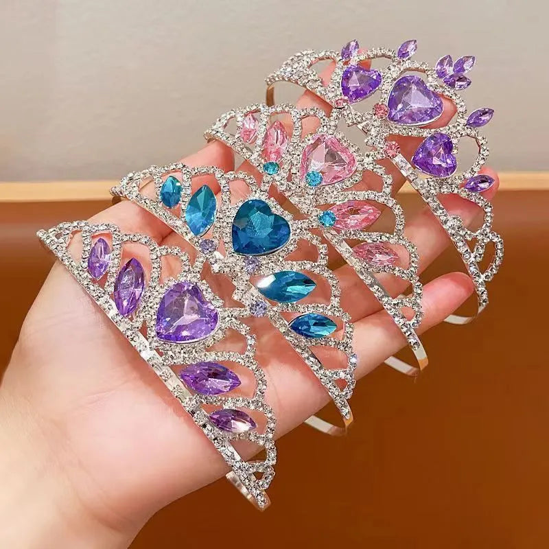 Children's metal headband with crystal crown design in pink, light blue, or light purple.