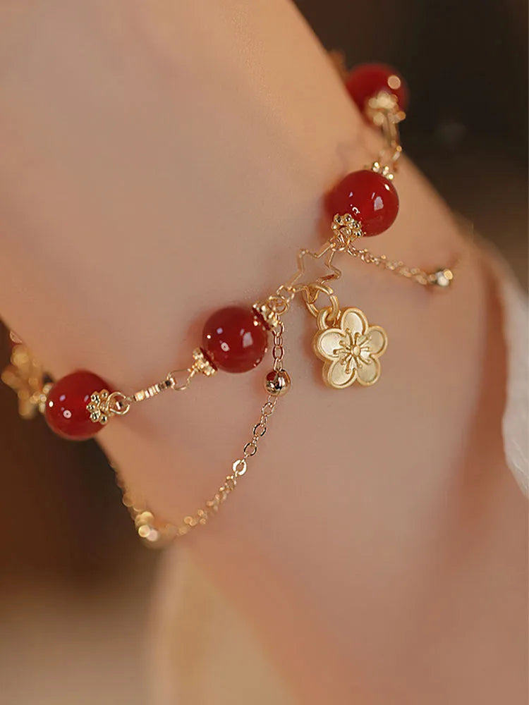 Red agate double layer women's bracelet with carved peach blossom and floral motifs.