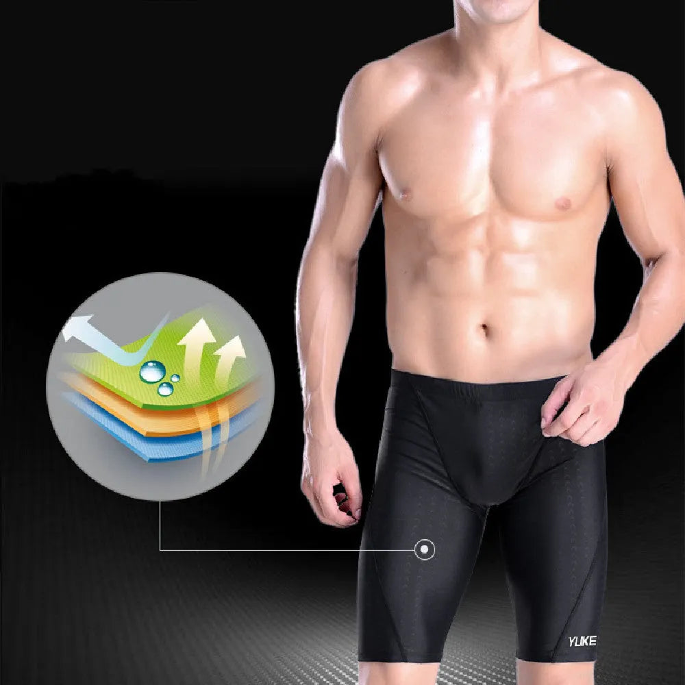 Men's black swimming set with briefs trunks, anti-fog goggles, waterproof cap, ear plugs, nose clip, and carry bag.