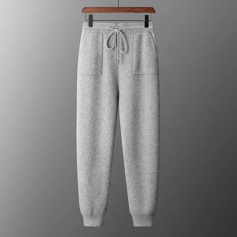 Men's light grey cashmere hooded sweatshirt and matching long pants laid flat.