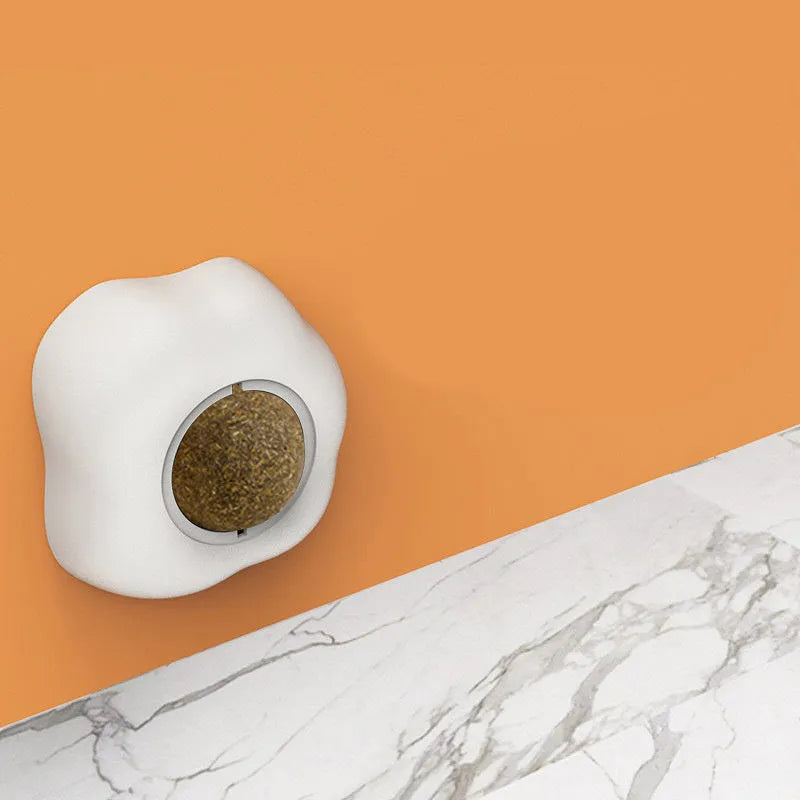 Interactive plush catnip ball toy stuck on a wall, showing Fried Egg and Poached Egg shape options.