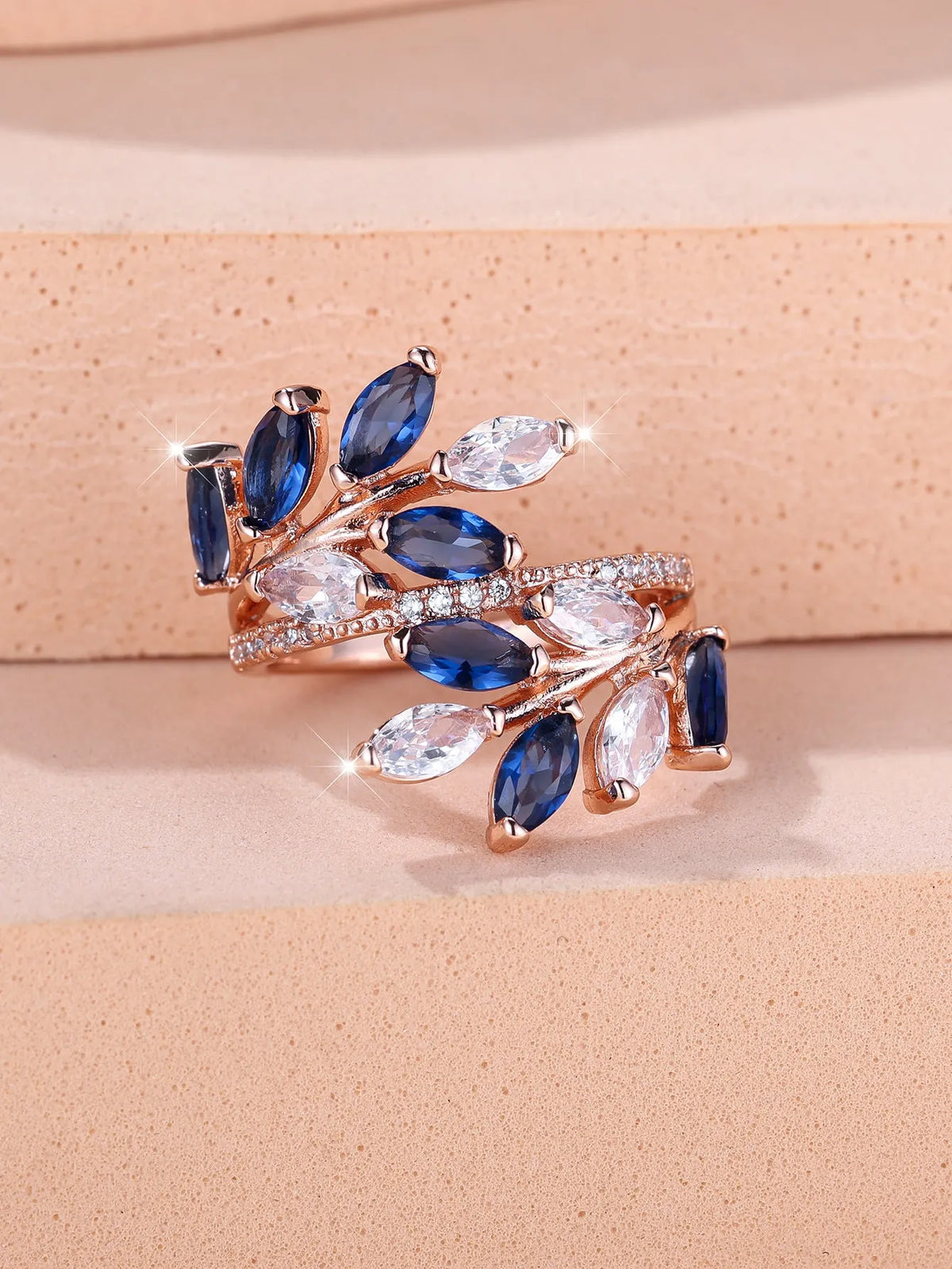 Adjustable copper leaf ring with zircon detailing in multiple colour options on display
