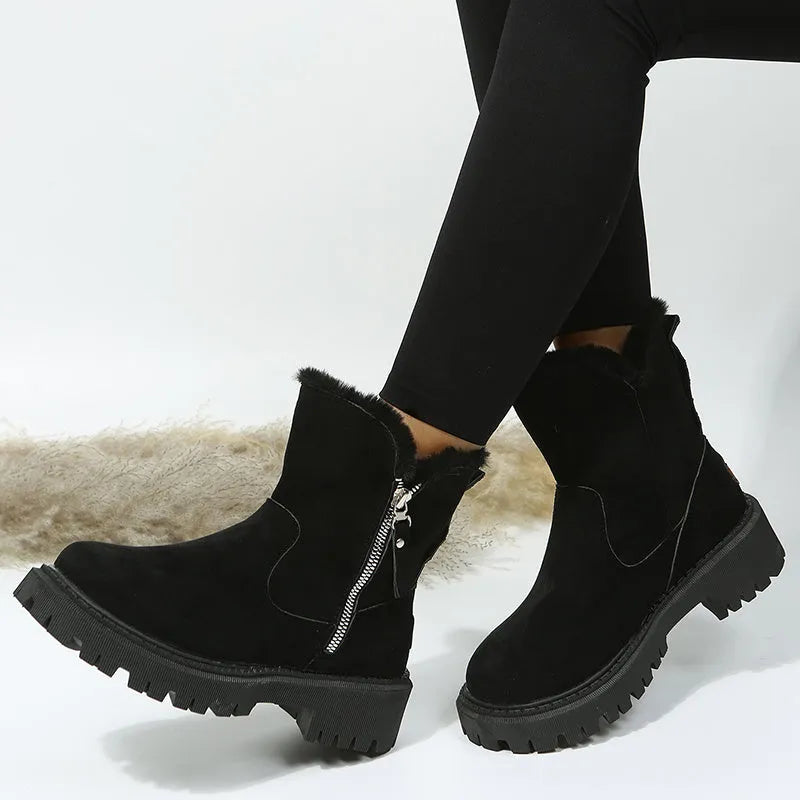 Women's black high-top snow boots with faux suede uppers, side zipper, and fluffy fur lining.