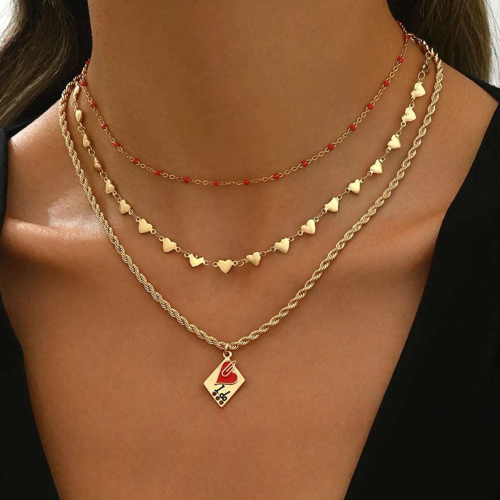 Close-up of a three-layer geometric love pendant on an adjustable zinc alloy clavicle chain.