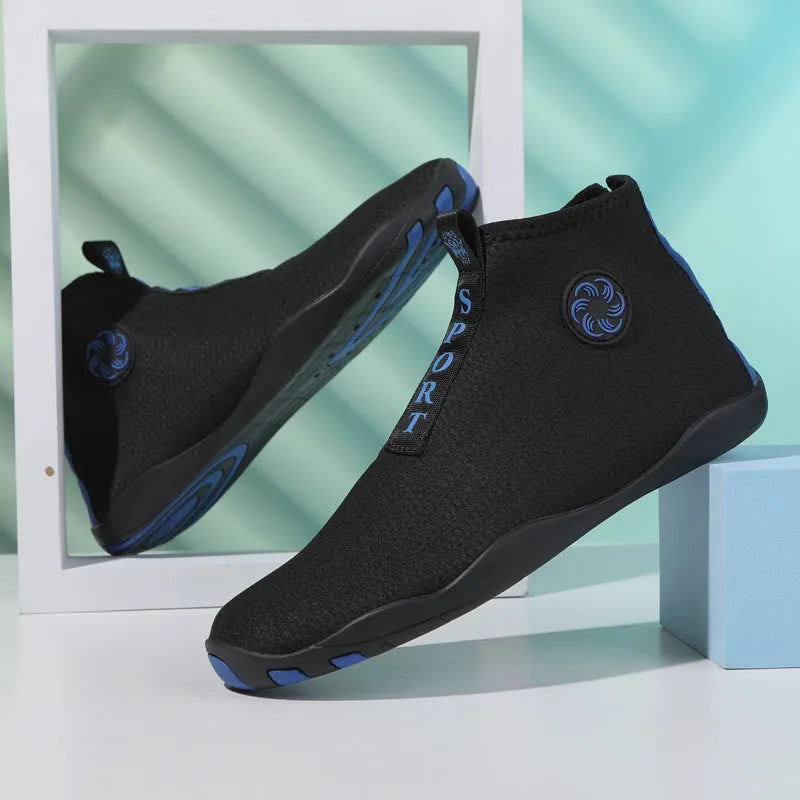Men's black and fluorescent green quick-dry mesh beach shoes with a non-slip rubber sole on a rocky surface.