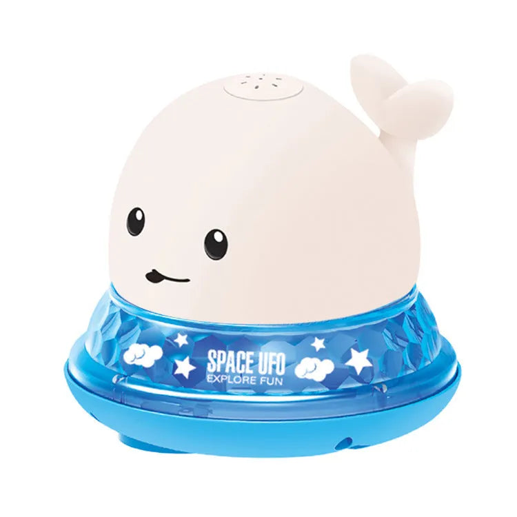Whale-shaped electric bath toy spraying water with coloured LED lights, shown with base unit on blue background
