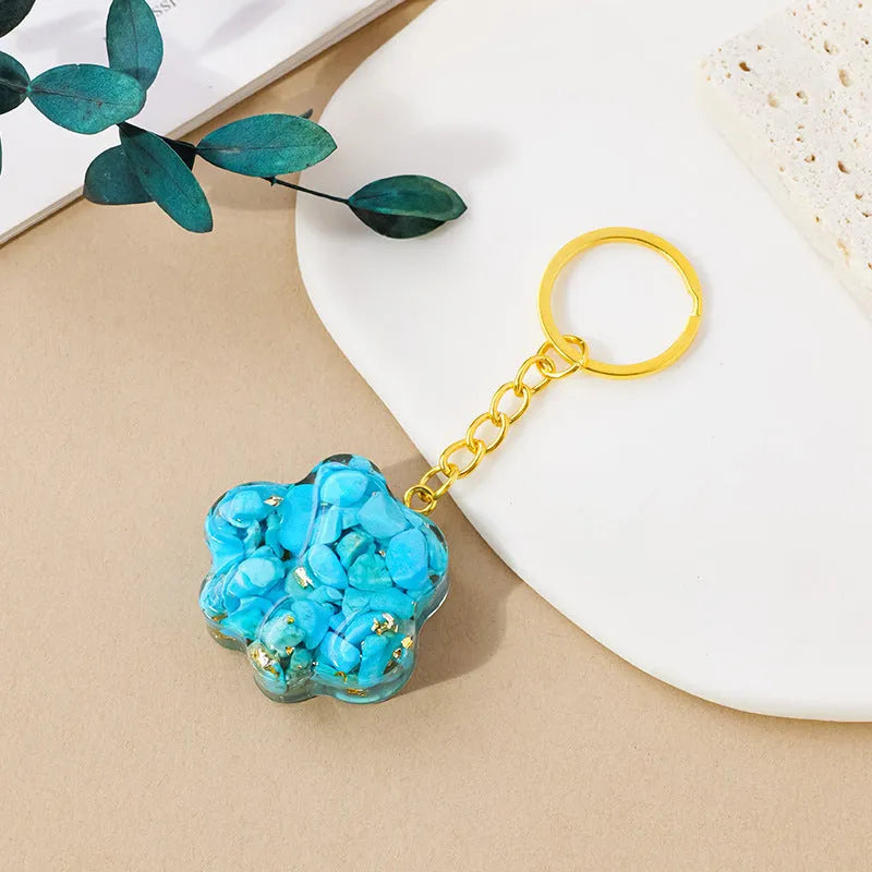 Small handcrafted crystal cat's paw shaped keychain pendant on a keyring.