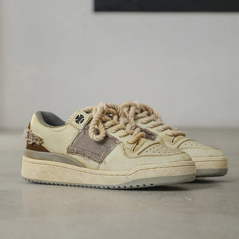 Beige low-top skateboard shoes with microfiber upper and rubber soles on white background