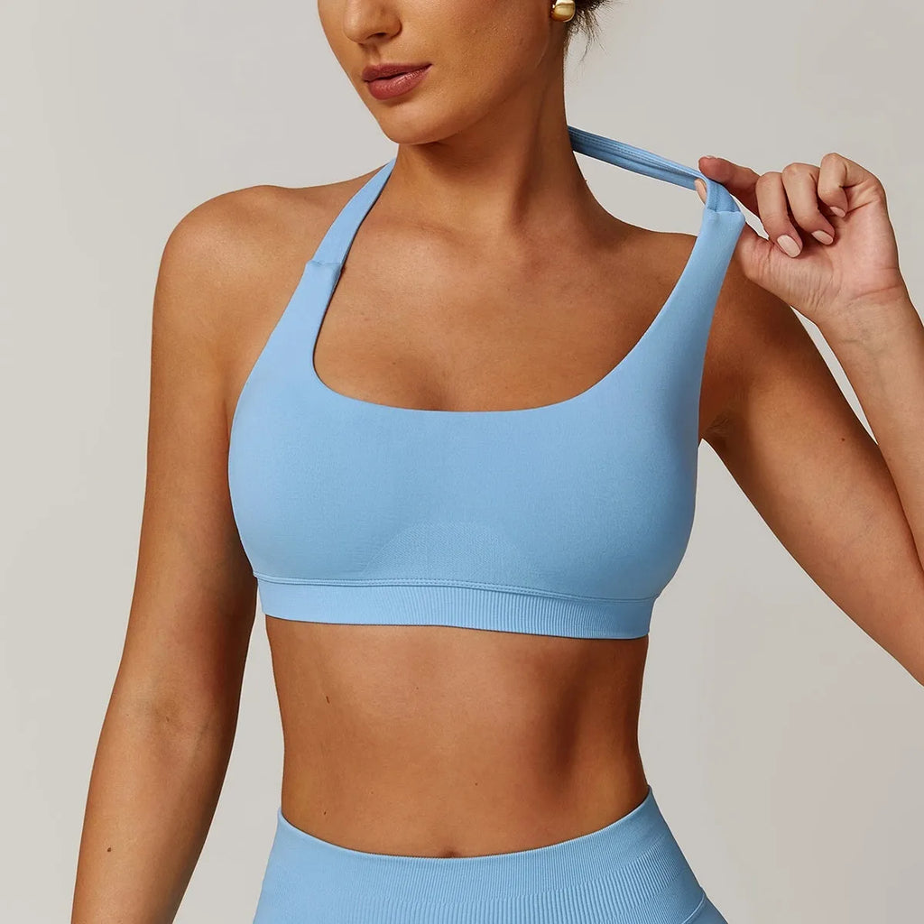 Women's black halter neck yoga sports bra with a removable padded insert.