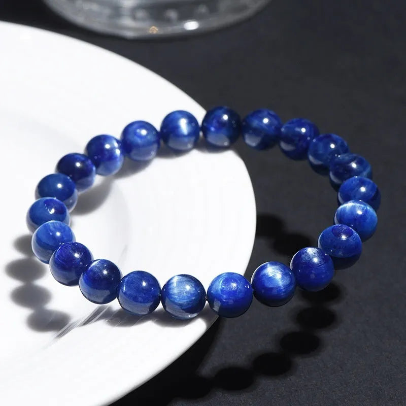 Natural blue crystal geometry ball bracelet with Ruyi charm on a white background.
