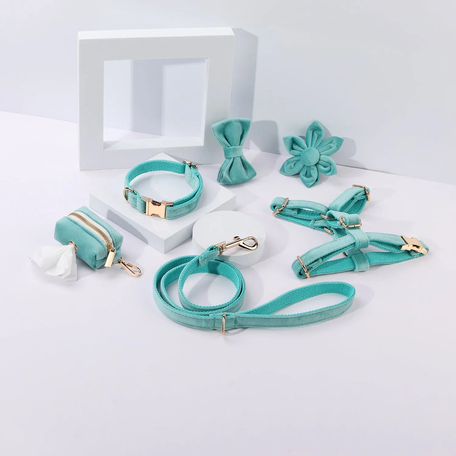 Complete velvet dog collar and traction rope set with bow tie, flower, and toilet bag on a table