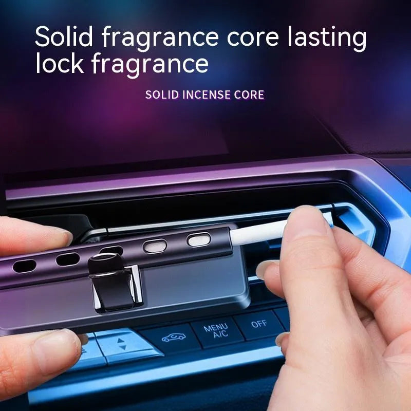 Black automobile aromatherapy air outlet ambience light with LED illumination on car dashboard