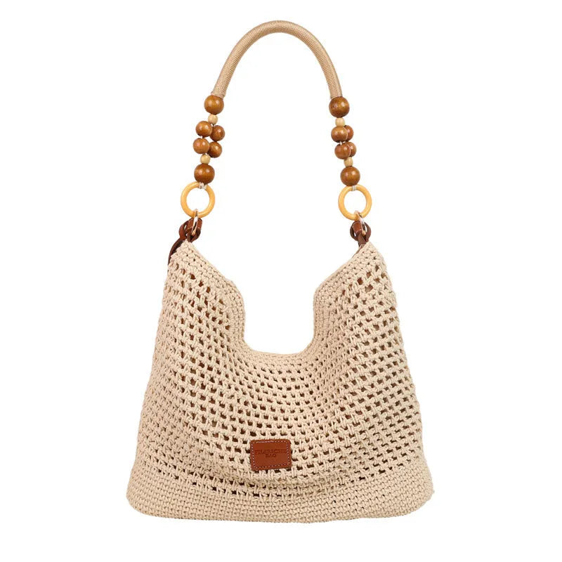 Black knitted bucket tote bag with contrast stitching showing internal zipper compartment