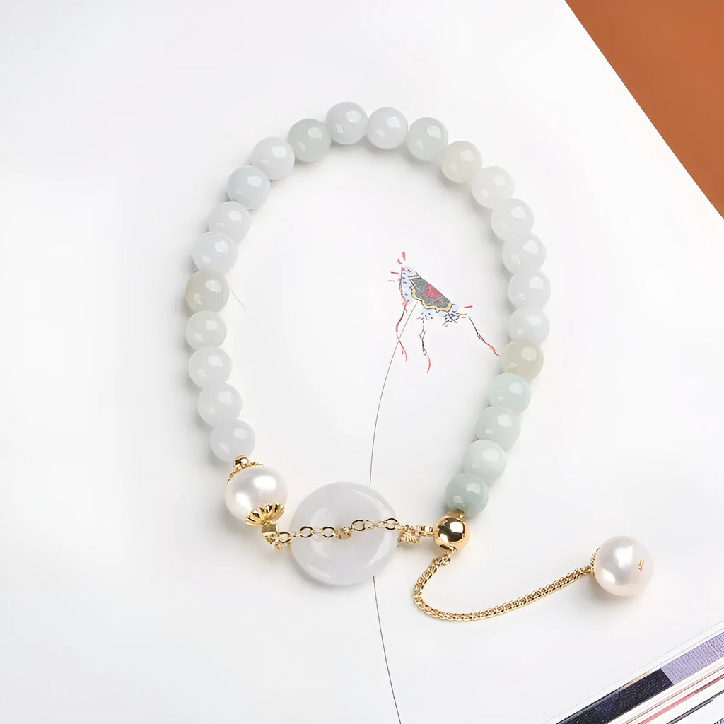 Natural emerald jade bracelet with pearl elements and peace buckle charm on adjustable cord