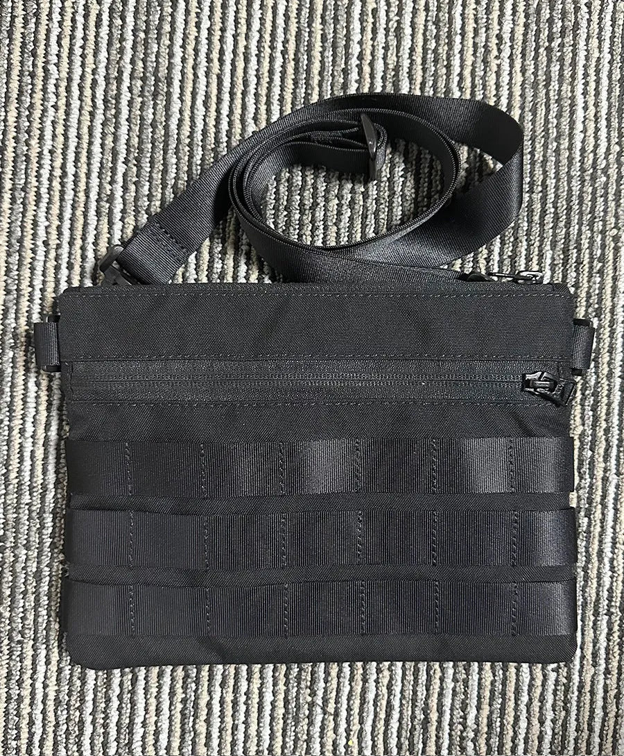 Black Oxford cloth military kit bag showing compact 18cm by 3.5cm size.
