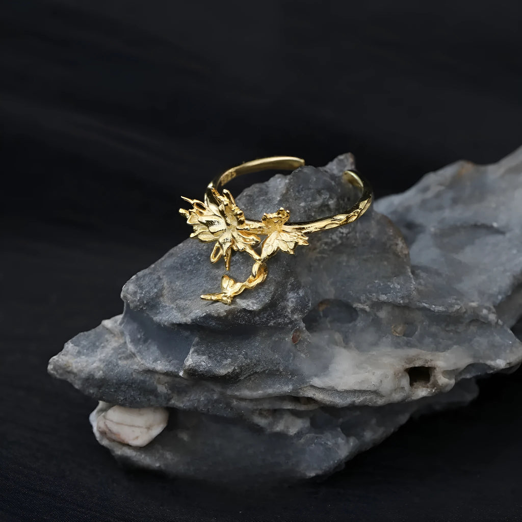 Women's adjustable silver ring with a wild butterfly design, shown in white gold and 18K gold colour finishes.