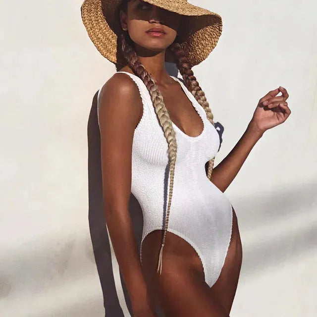 Women's solid colour one-piece swimsuit in wrinkled seersucker fabric with backless design