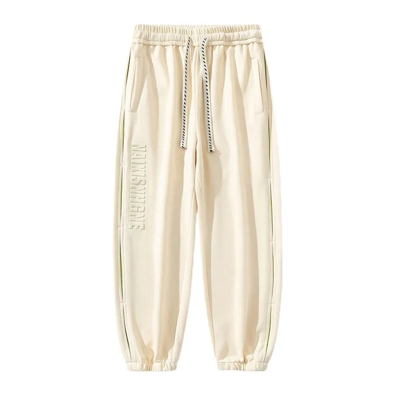Men's loose-fit cotton trousers with stitching print detail and a banded ankle cuff.