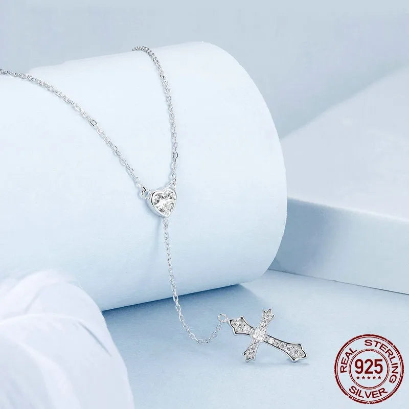 Silver V-neck Love Cross pendant on an O-ring chain necklace for women.