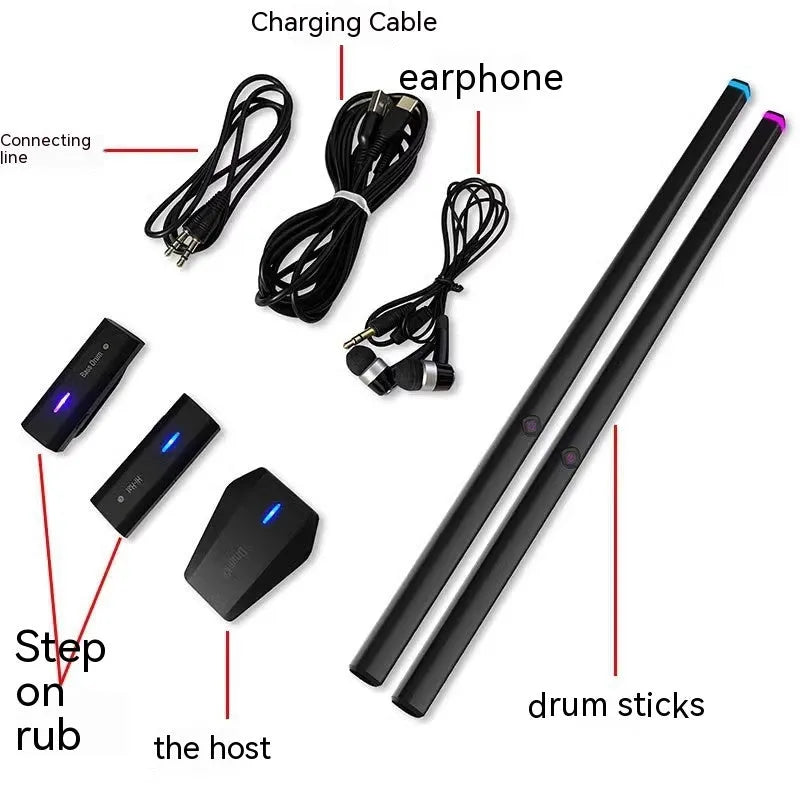 Black wireless air drum kit with drumsticks and headphones on table