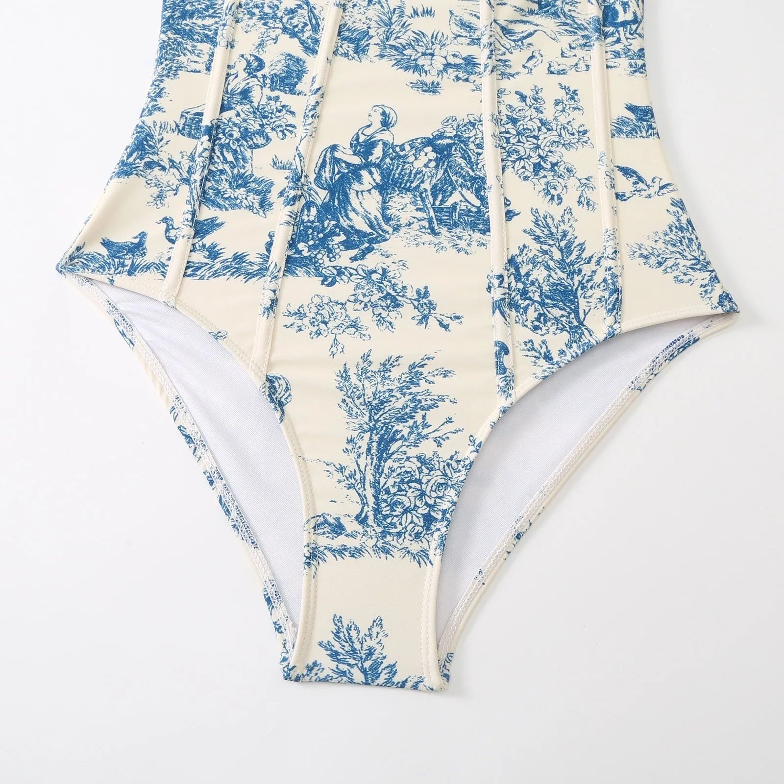Blue women's one-piece swimsuit with matching gauze skirt on size chart