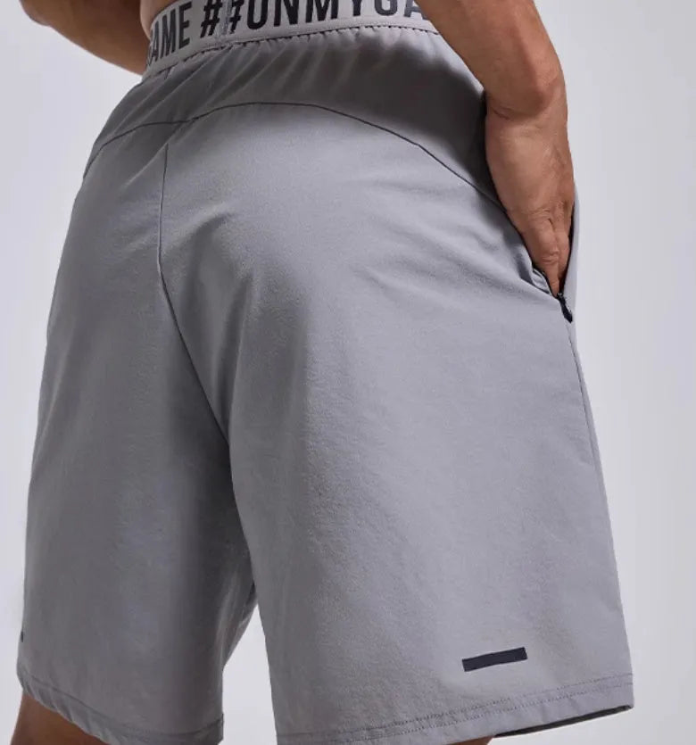Men's black loose fit cropped workout shorts with elastic waistband and letter detailing