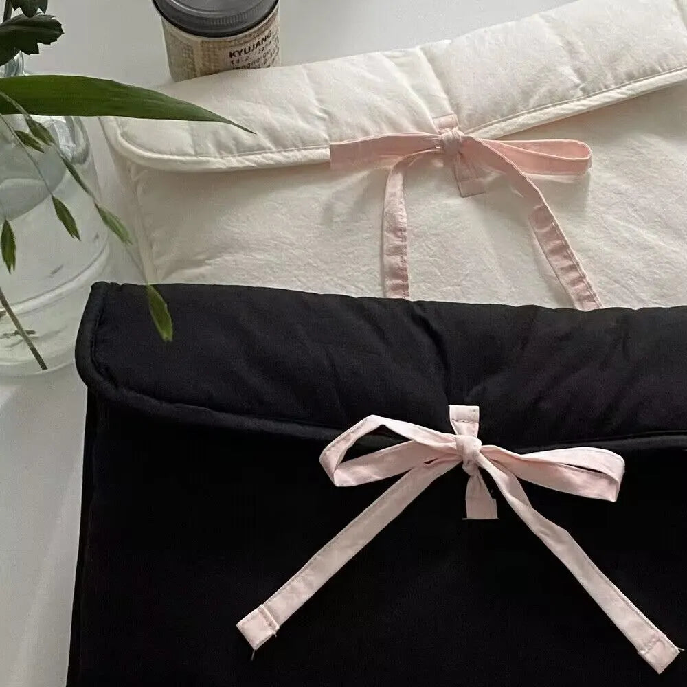 Women's black quilted computer bag with ballet bow and striped lining