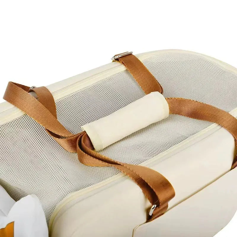 Beige hard-sided pet travel crate with a one-shoulder carry strap, shown with dimensions 43cm by 25cm by 22.5cm.