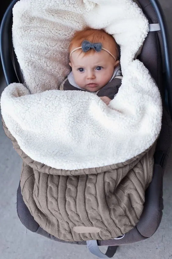 Envelope-style baby stroller sleeping bag in beige colour showing thick cotton wool filling and soft lining.