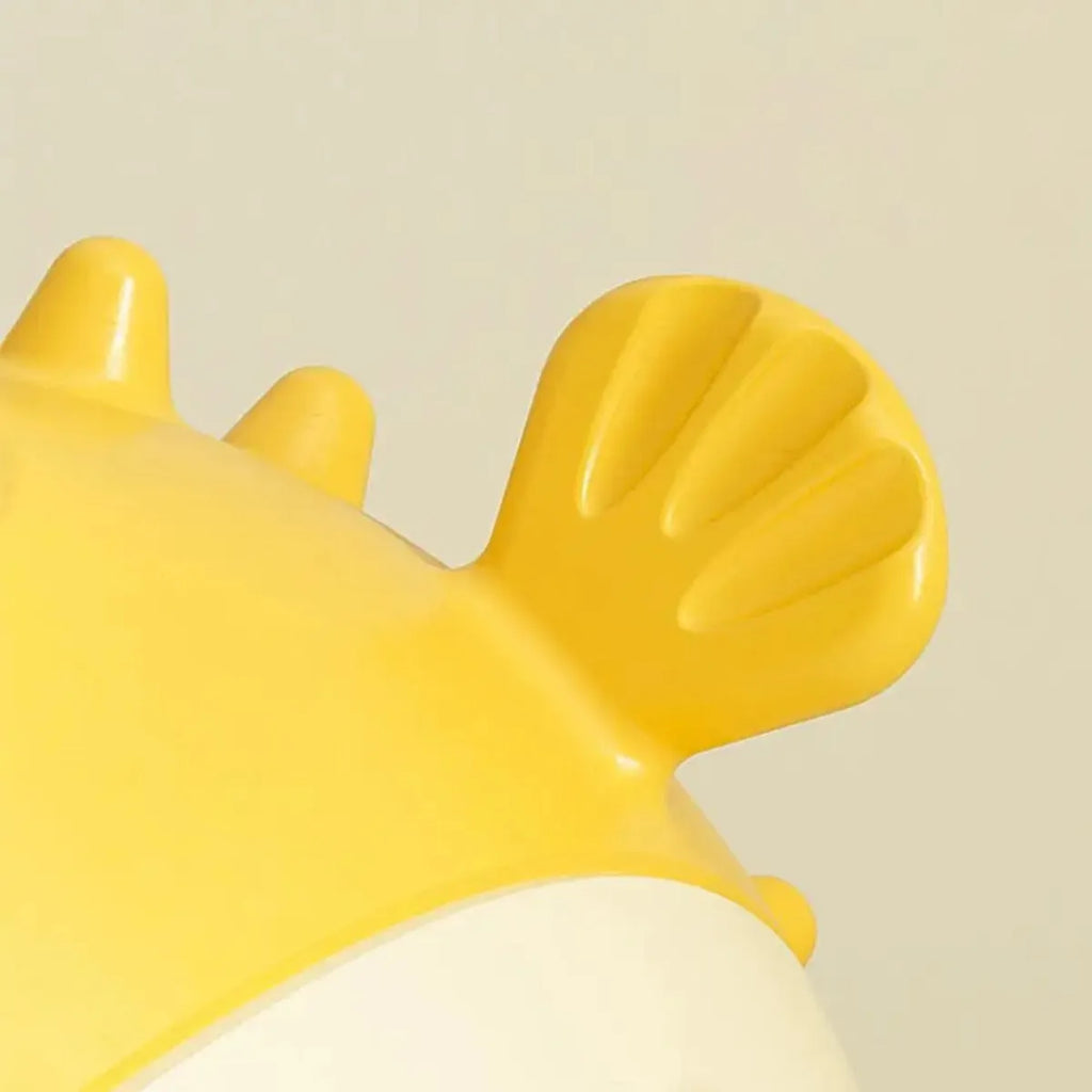 Yellow fish-shaped durable vinyl dog chew toy with textured surface for dental care.
