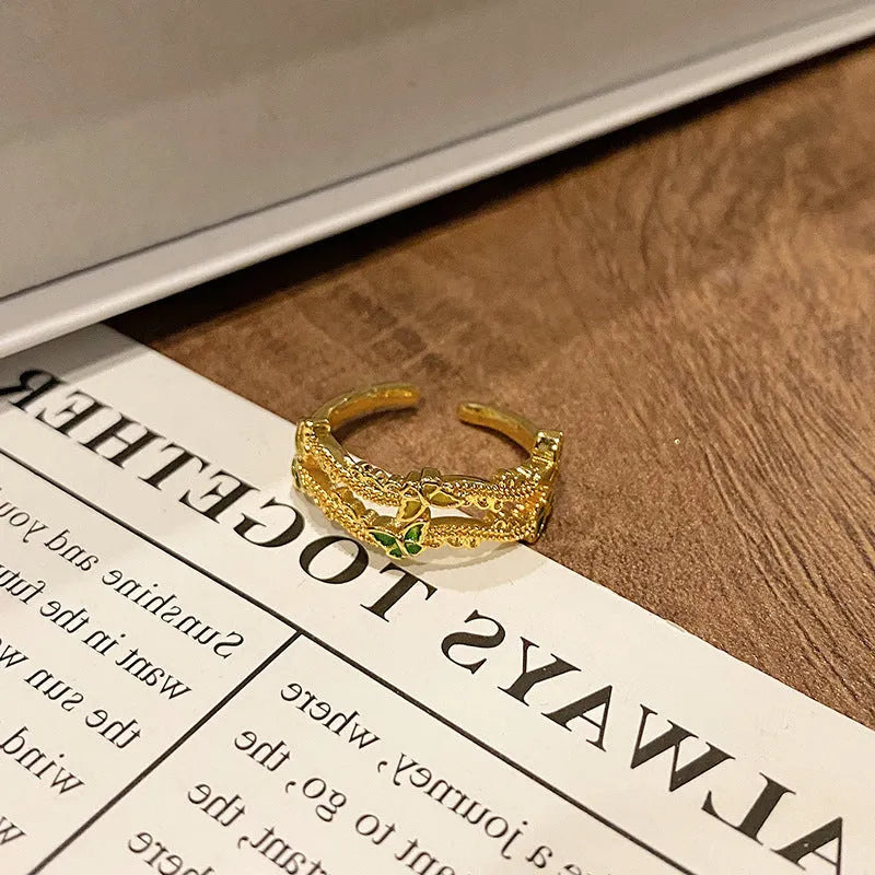 Copper butterfly women's ring with drip oil finish in an open-loop design.
