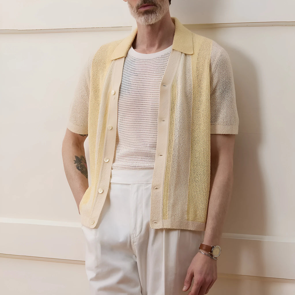 Yellow asymmetric hollow-out short-sleeved polo shirt on a hanger