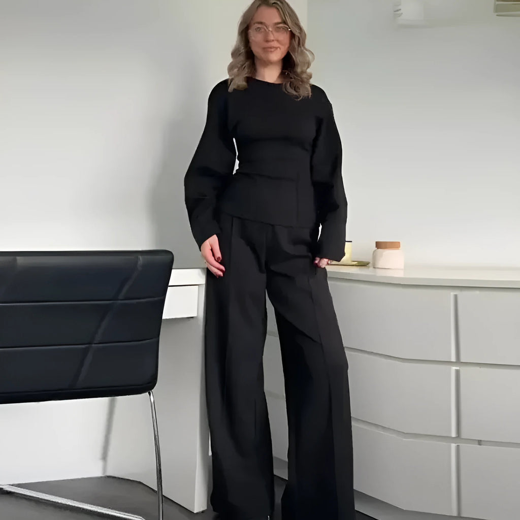 Women's black polar fleece long sleeve pleated top and wide leg trousers suit set.