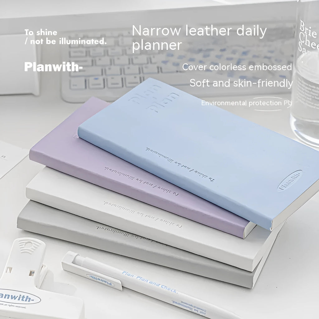 A5 embossed meter notebook open on a desk, showing white 100gsm paper and a choice of five cover colours.