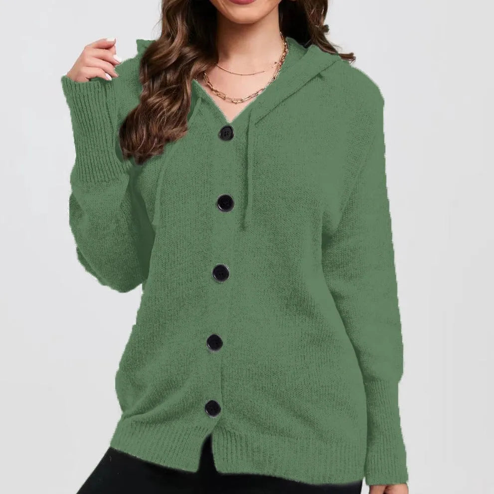 Woman wearing a thick, loose-fit hooded cardigan sweater in a solid colour with a 3D textured pattern.