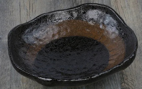 Japanese style irregular shaped ceramic sashimi bowl with floral decoration on porcelain