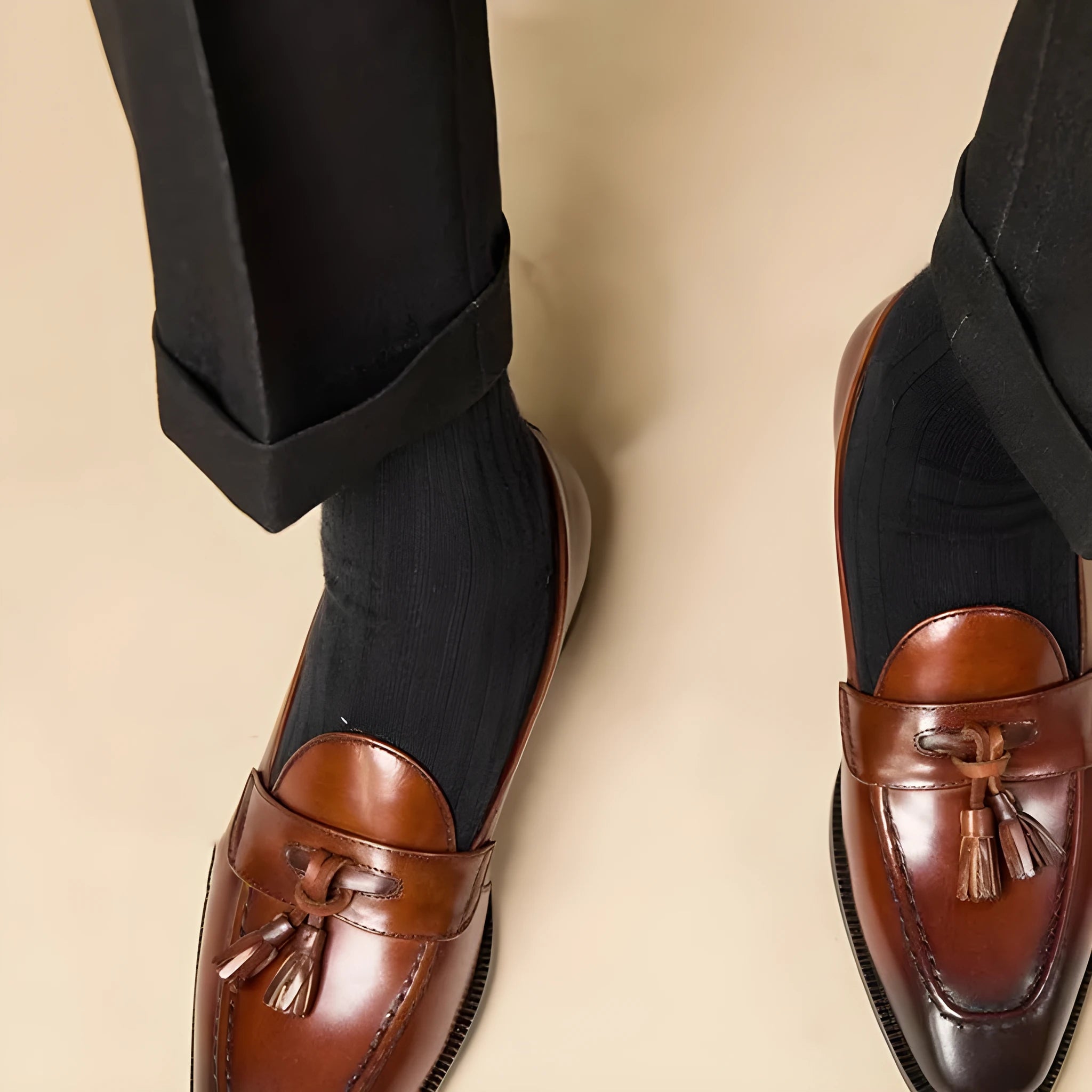 British-style leather tassel loafers in polished black leather with rubber sole