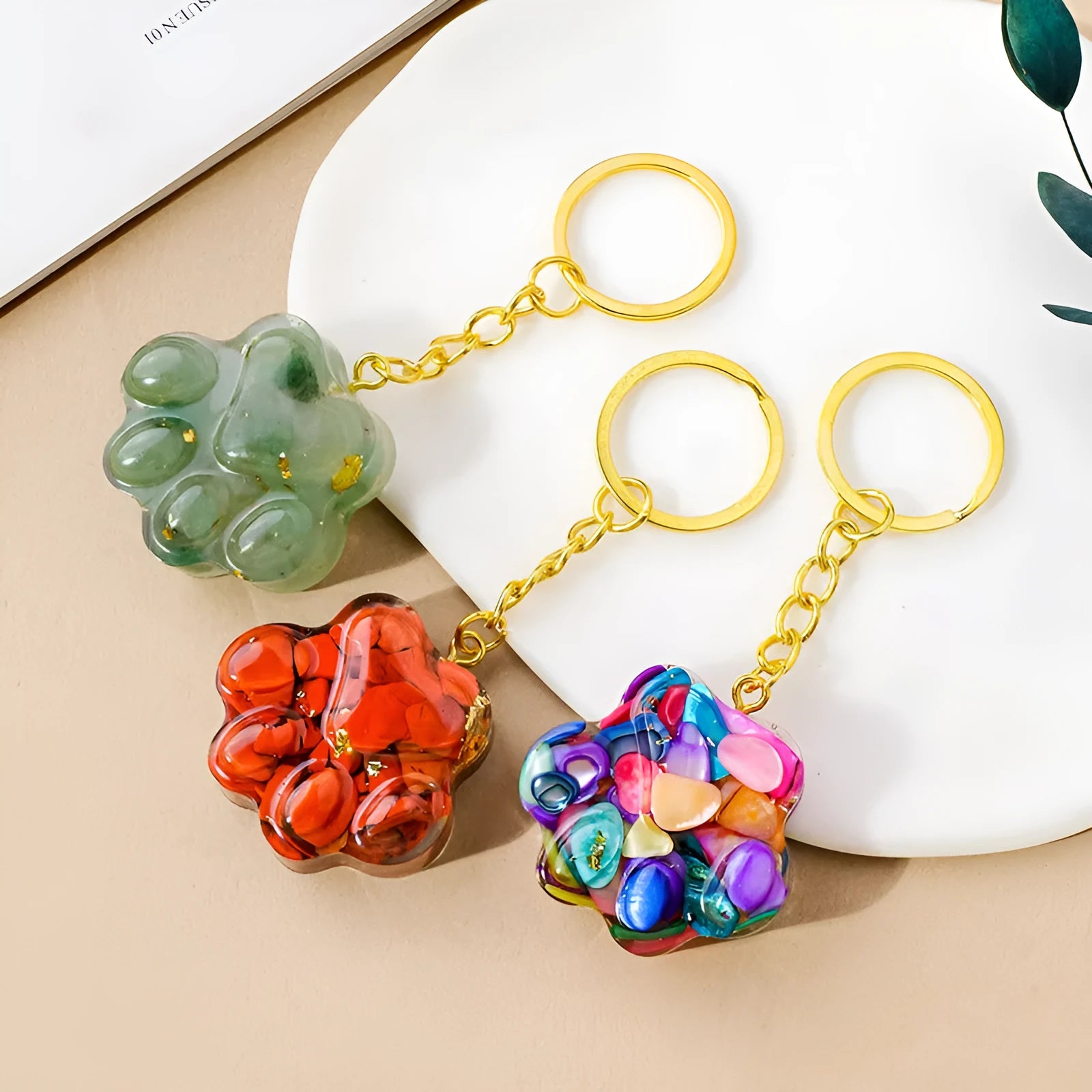 Small handcrafted crystal cat's paw shaped keychain pendant on a keyring.