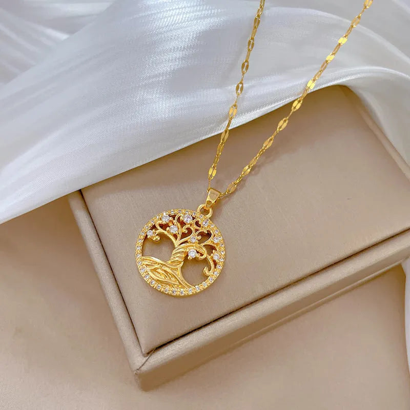 Gold plated necklace with tree and cross pendant featuring mother of pearl and rhinestones on adjustable chain