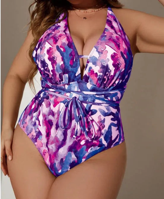 Adult woman wearing a solid blue one-piece halter swimsuit with a bikini-style design.