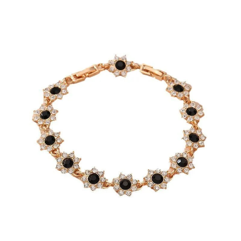 Flower-shaped bracelet with gemstone accents in gold or silver electroplated finish showing twelve colour combination options