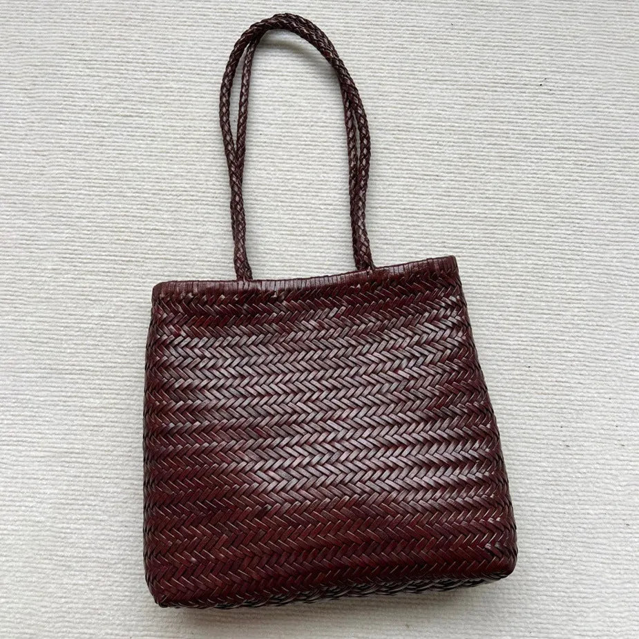 Brown handmade woven tote bag with three-dimensional pocket design and cowhide leather construction