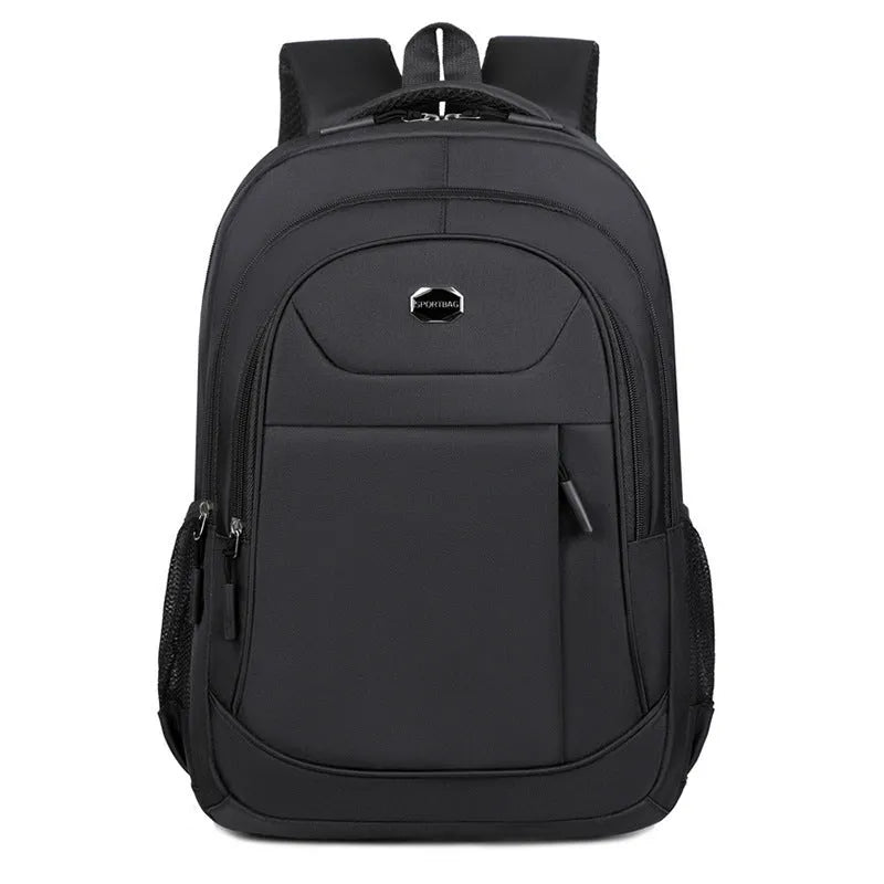 Solid colour Oxford cloth backpack with curved shoulder straps, shown in black, blue, green, or red.
