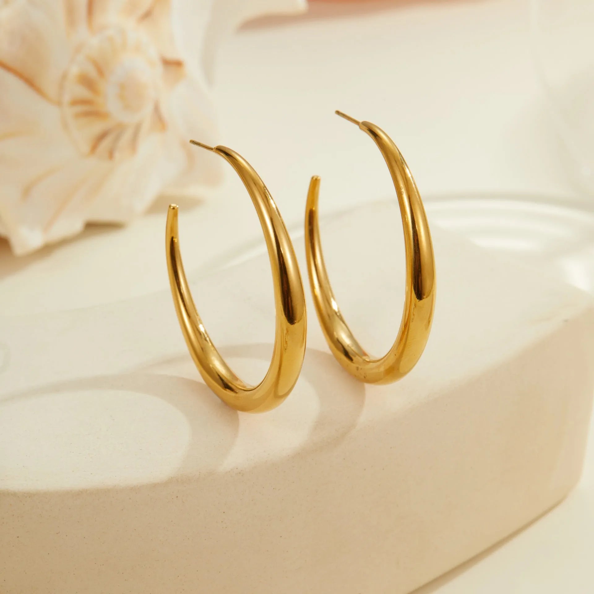 Simple geometric round hoop earrings in gold and steel finish made of stainless steel with 18K PVD plating